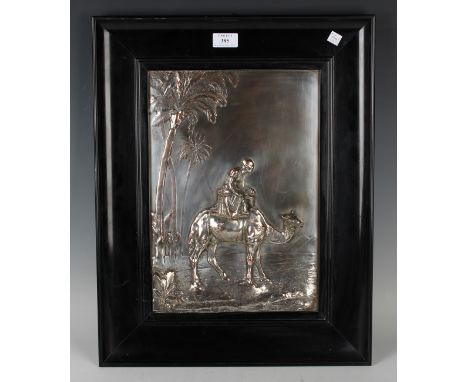 A late Victorian plated-on-copper panel depicting a figure seated on a camel beneath a palm tree, 37.5cm x 26cm, within eboni