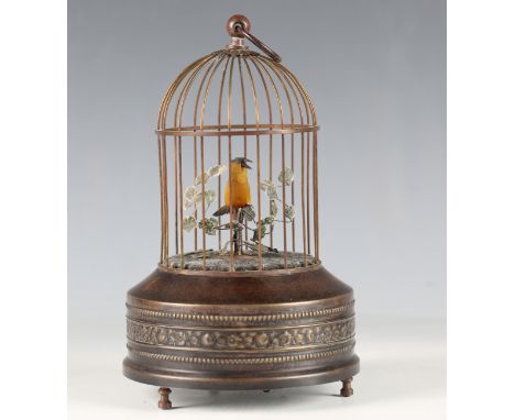 A 20th century patinated brass novelty musical birdcage automaton, the cage enclosing a moving and singing bird, height 23.5c