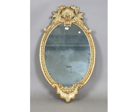 A modern rococo style gilt framed oval wall mirror, 102cm x 60cm.Buyer’s Premium 29.4% (including VAT @ 20%) of the hammer pr