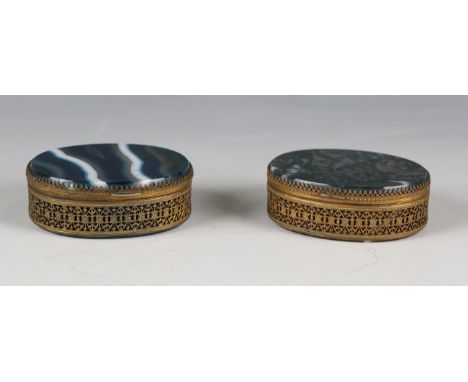 Two late 19th century gilt metal oval trinket boxes, each set with varicoloured banded agate, with hinged lid and foliate pie