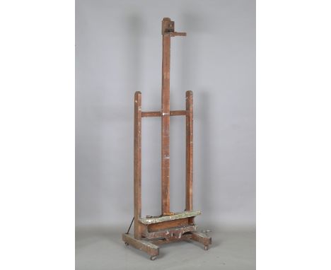 An early 20th century oak framed artist's easel, formerly owned and used by Sir Frank Brangwyn RA, with central winding mecha