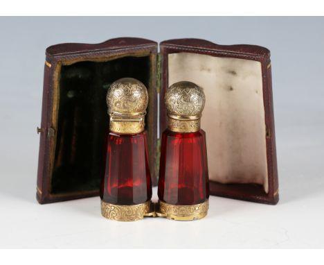 A late Victorian ruby glass and silver gilt folding 'binocular' scent bottle by S. Mordan &amp; Co, the central hinge opening