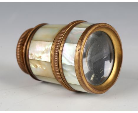 A 20th century gilt metal two-draw monocular telescope with mother-of-pearl sides, length fully extended 10cm.Buyer’s Premium
