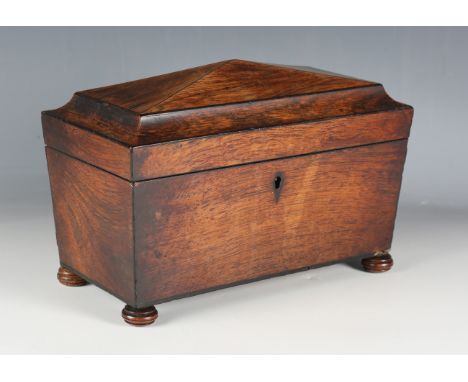 A Regency rosewood tea caddy of sarcophagus form with compartmentalized interior, on turned bun feet, height 21cm, width 31cm