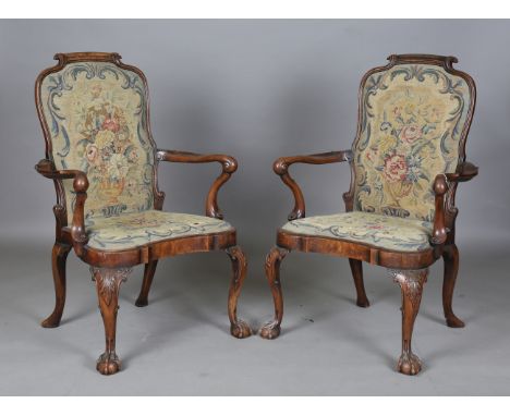 A fine pair of early 20th century Queen Anne style walnut framed elbow chairs, the seat and back pads finely worked in wool, 