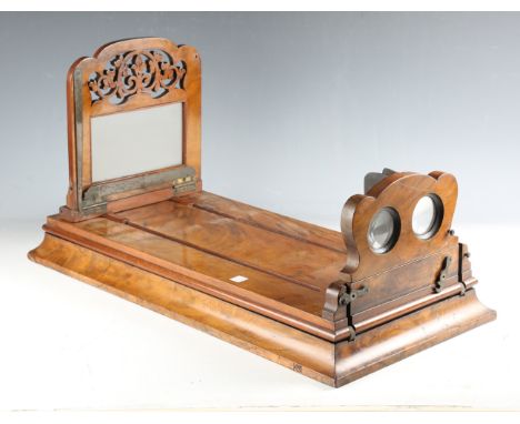 A Victorian walnut table-top stereoscopic viewer, raised on a graduated rectangular base, length 61cm, a small group of mahog