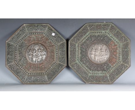 A pair of 19th century Indian copper and silver mounted chargers, each of octagonal form, the circular centre embossed with f