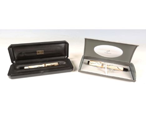 A Parker Duofold International fountain pen and a matching ballpoint pen with pearl and black casing, length 13.2cm, boxed.Bu