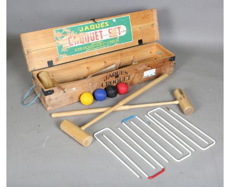 A late 20th century Jaques croquet set, comprising four mallets, six steel hoops, four balls and a centre stick, cased.Buyer’