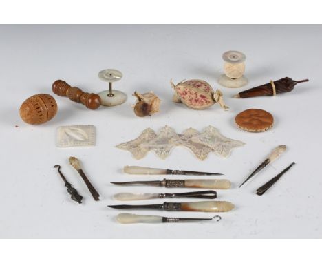 A collection of mainly late 19th and early 20th century sewing items, including a carved mother-of-pearl spool, four matching