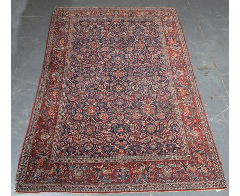 An Esfahan rug, Central Persia, early 20th century, the blue field with overall strapwork scrolls supported by palmettes and 