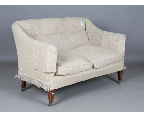 An Edwardian two seat sofa, raised on mahogany square tapering legs and castors, height 84cm, width 125cm, depth 78cm.Buyer’s