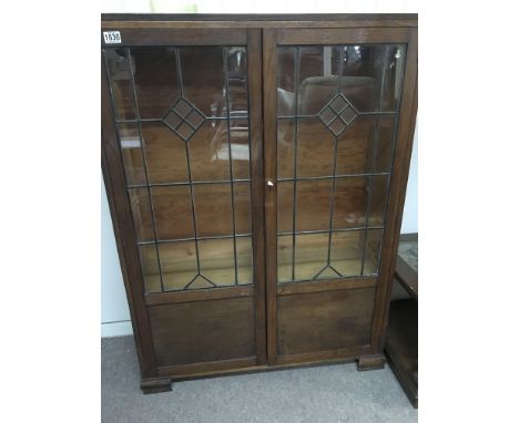 An oak Arts and crafts style lead light glazed bookcase no shelfs has a key. 90cm x 123cm- NO RESERVE
