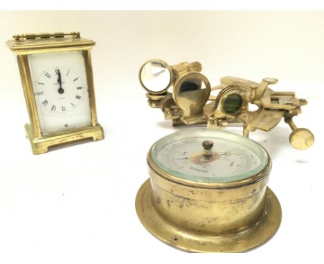 A brass french carriage clock with wind up movement, brass sextant and small brass barometer. Postage category D