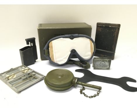 A Collection of WW2 items including a German MG 34 oil can, Matchbox holder, US goggles, MP 40 magazine loader etc