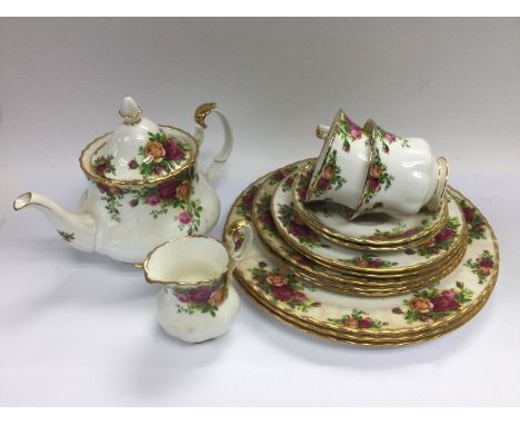 A collection of Royal Albert Old Country Roses tea and dinnerware. One dinner plate and the teapot are first quality, the oth