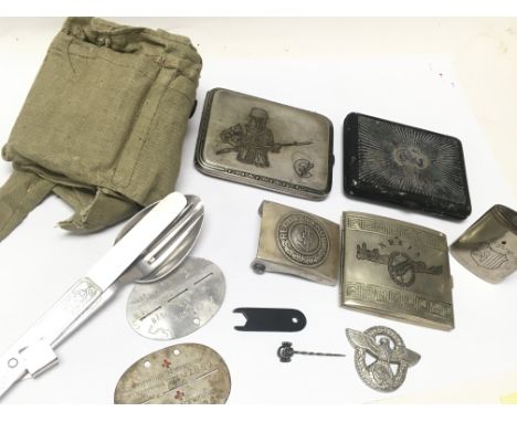 A Collection of retrospective WW2 Third Reich items including a cap badge, German NCO/ officer eating utensil, silver skull e