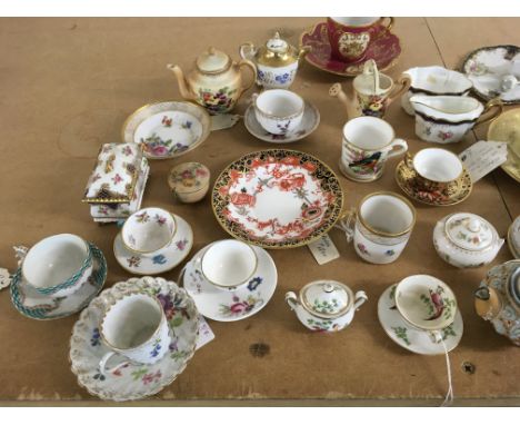 A collection of miniature cups and saucers including Derby and Dresden.