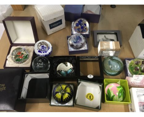 A collection of paperweights including Caithness