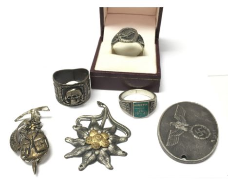 A collection of retrospective WW2 Third Reich items including A Gerbirgsjager Edelweiss badge, A Secret Police Gestapo Warran