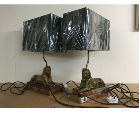 A pair of Art Deco lamps in the form of a Sphinx , on step marble bases, with Brand new green shades