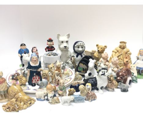 A collection of Wade porcelain figurines including Alice in wonderland, whimsies, Pantomime Dame- NO RESERVE