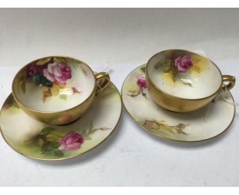 A Collection of four Royal Worcester cabinet cups decorated with flowers and foliage.