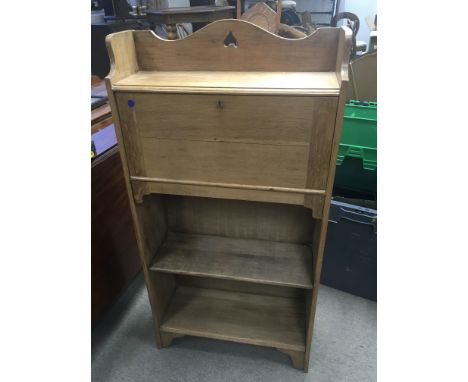 An Arts and Crafts style light oak bureau bookcase with a fall front above a fitted interior.