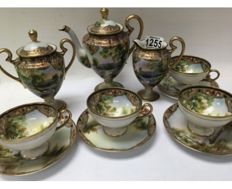 A Japanese noritake tea set comprising tea pot milk jug and sugar bowl with four cups and saucers.