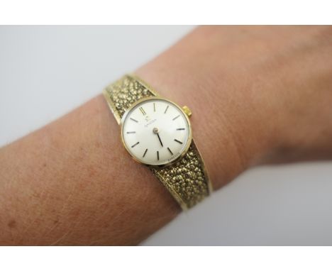 Omega 9ct gold lady's bracelet wristwatch, circa 1979, champagne coloured circular dial, 17mm diameter, with baton numerals, 