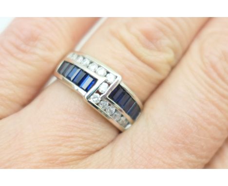 Sapphire and diamond cluster ring, channel set with thirteen brilliant cut diamonds and ten baguette sapphires, all in 14ct w