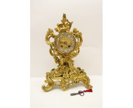 French ormolu mantel clock, circa 1880, in Rococo Revival style, the dial with enamelled blue and white Roman numerals set wi