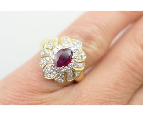 Ruby and diamond cluster ring, the oval cut ruby of approx. 1ct, bordered with small brilliant cut diamonds in a stepped flow