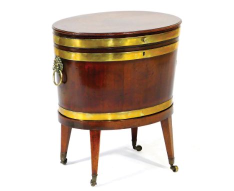 George III mahogany cellarette, circa 1790, oval form with hinged cover, brass banded and with cast brass lion mask and ring 