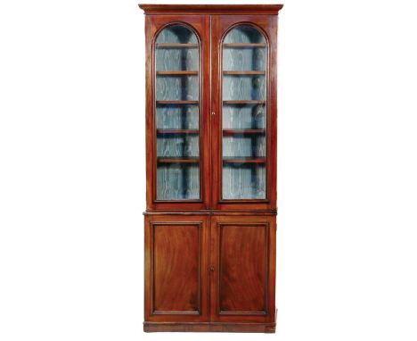 Victorian mahogany library bookcase, circa 1870, the top with an ogee moulded cornice over two moulded arched glazed doors op