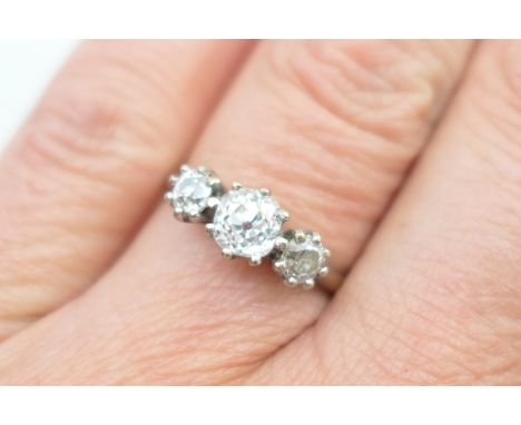 Diamond three stone ring, centred with an old brilliant cut stone of approx. 0.7ct, flanked on either side with a smaller old
