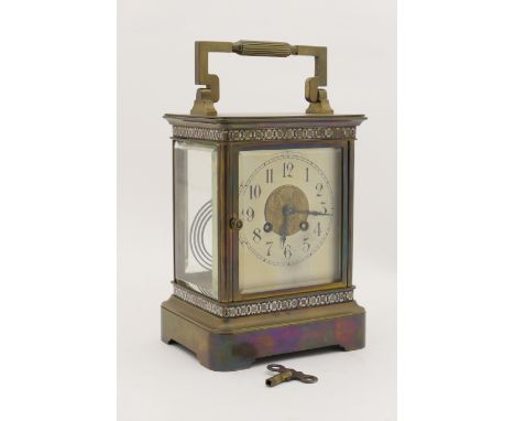 French brass mantel clock, silvered dial with Arabic numerals, centred with a brass relief and bordered top and bottom with c