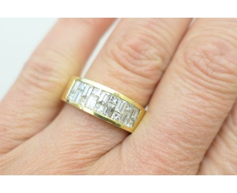 Diamond cluster ring, the 18ct yellow gold plain band channel set with a mosaic of nine baguette and nine princess cut diamon