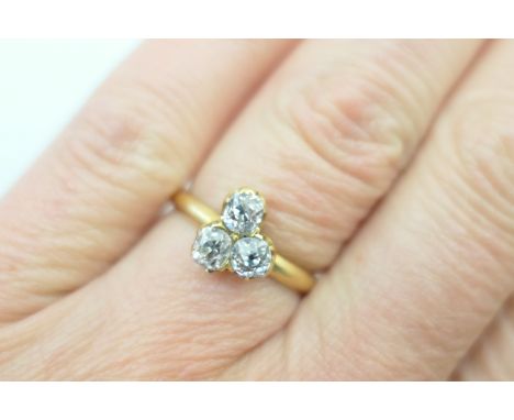 Diamond cluster ring, having three old cushion cut stones, totalling approx. 0.65ct, in an 18ct yellow gold claw mount and ri