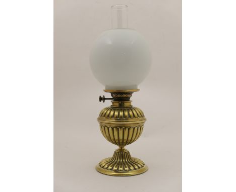 Victorian pedestal oil lamp, with milk glass globular shade, over a reeded brass tank and flared base, height with chimney 50
