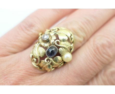 Arts and Crafts style gem set dress ring, set with rose cut diamond, cabochon sapphire and a pearl within entwined leaves and