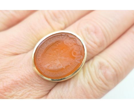 Cornelian intaglio seal ring, the seal early 19th Century, carved on one side with an armorial crest with the motto 'Mortem P