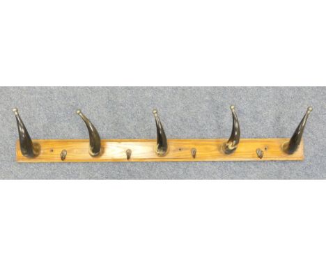 Novelty cow horn hat and coat rack, long pine panel supporting five ox horns and four coat hooks, width 123cm