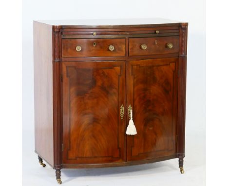 Regency mahogany bowfront side cabinet, circa 1810-20, the top with broad crossbanding over a brushing slide and two frieze d