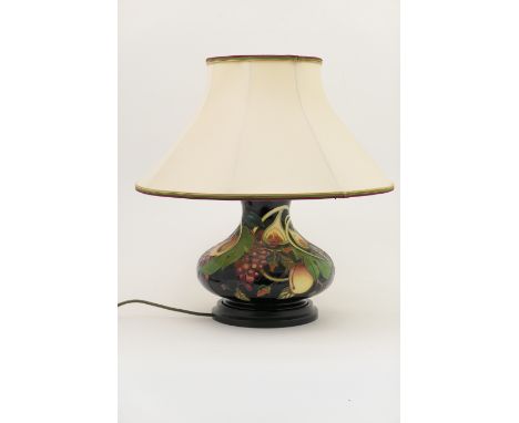 Moorcroft Queen's Choice table lamp, baluster form decorated with figs, peaches and grapes against a deep blue ground, wooden