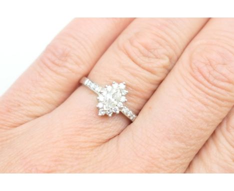 Diamond cluster ring, the central marquise cut diamond bordered with small brilliants and with further diamonds set to the sh