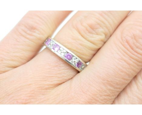 Pink sapphire and diamond half eternity ring, the brilliant cut stones channel set in an 18ct white gold, size M, gross weigh