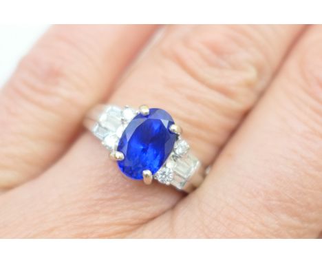 Attractive tanzanite and diamond cluster ring, in 18ct white gold, the oval cut tanzanite of good colour and estimated as app