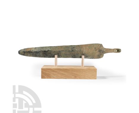 Circa 13th-6th century B.C. With a broad, lentoid-section blade and wide raised flange down centre, rounded tip, straight sid