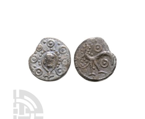 Circa 710-760 A.D. Obv: Woden head with seven bosses around. Rev: pecking bird within berry bush, ring and pellet above and b